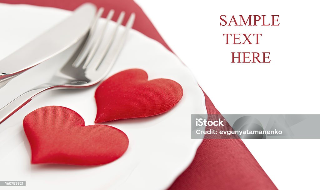 plate, fork, knife and red hearts table setting for Valentine's Day. plate, fork, knife and red hearts Arranging Stock Photo