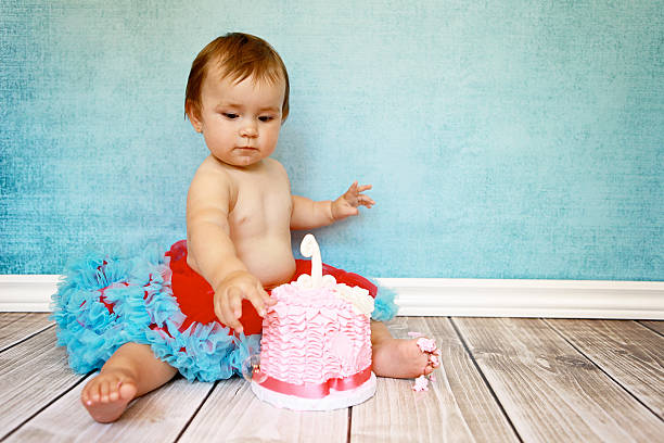 istock Baby Girl with First Birthday Cake 460760529