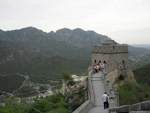 Beijing, China – May 24, 2012: A view of the Great Wall in Beijing, China. The Visitors are both locals and foreigners. They walk up and down the steep stairs.