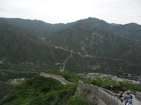 Beijing, China – May 24, 2012: A view of the Great Wall in Beijing, China. The Visitors are both locals and foreigners. They walk up and down the steep stairs.