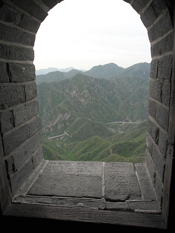 Beijing, China – May 24, 2012: A view of the Great Wall in Beijing, China. The Visitors are both locals and foreigners. They walk up and down the steep stairs.