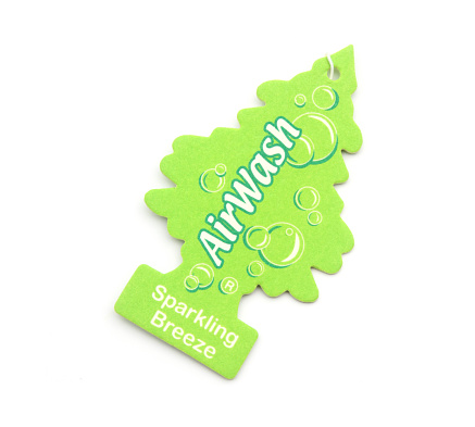 West Palm Beach, USA - December 15, 2013: An Air Wash scented air freshener made by the Car Freshner Company. It is cut in the shape of a tree and designed to be hung from a car's rear view mirror to keep the car's interior smelling fresh and aromatic.