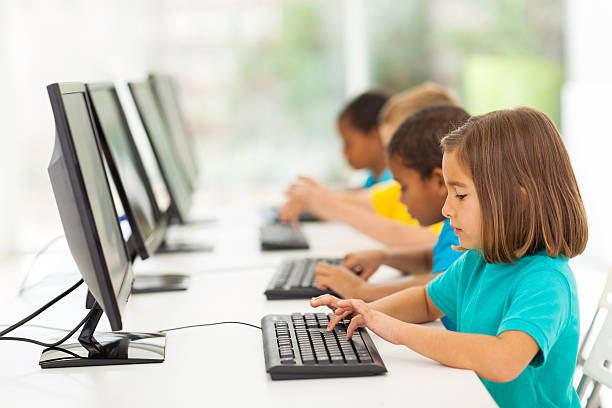 elementary school students in computer class group elementary school students in computer class computer lab stock pictures, royalty-free photos & images