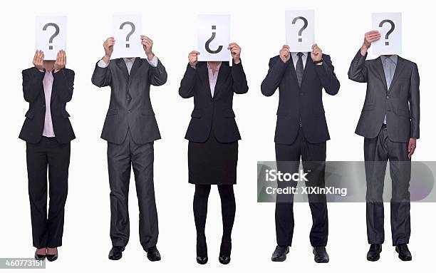Business People Holding Up Paper With Question Mark Stock Photo - Download Image Now