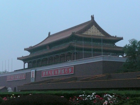Beijing, China – May 21, 2012: The Entrance to the forbidden city with Portrait of Mao. The portrait on the wall is Chairman Mao Zedong, and the text on each side reads \