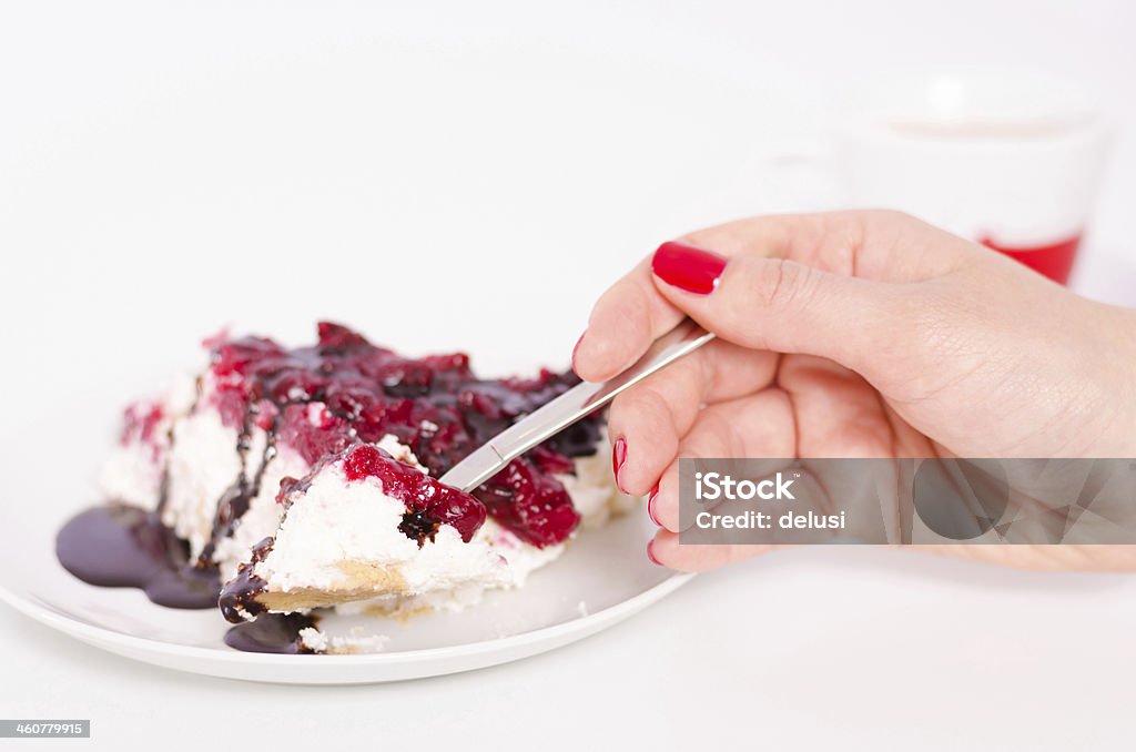 Delicious handmade slice of cheese cake Cutting and eating delicious handmade cheese cake slice with a spoon and a cup of coffee on a white background Baked Stock Photo