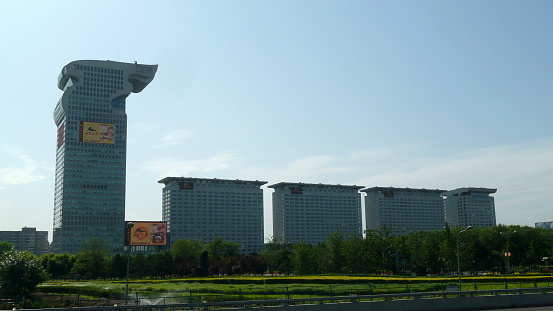 Beijing, China - May 24, 2012: A view of the dragon-shaped building of Pangu Plaza, Beijing, China. It is located next to Beijing National Stadium (The Bird’s Nest).  Visitors in front of Beijing National Stadium can easily see this dragon-shaped Pangu Plaza.