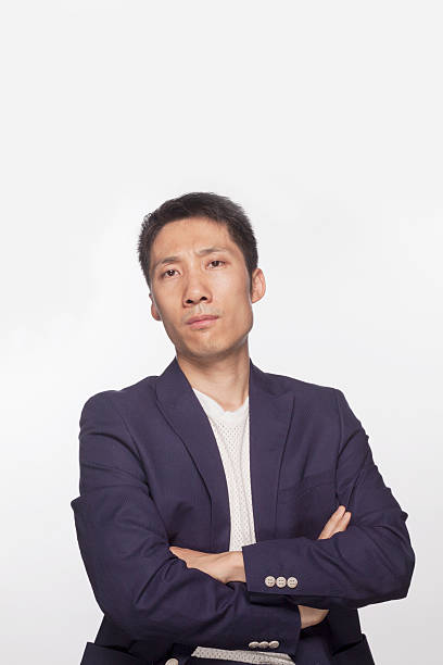 istock Serious man with arms crossed looking at camera, studio shot 460782847