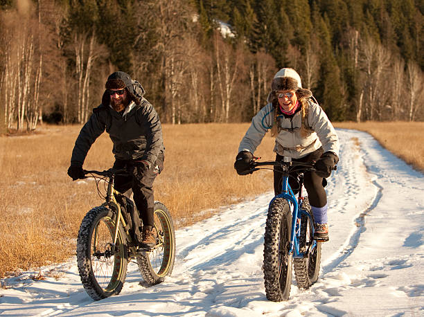 istock Couple riding fatbikes in the snow 460784373
