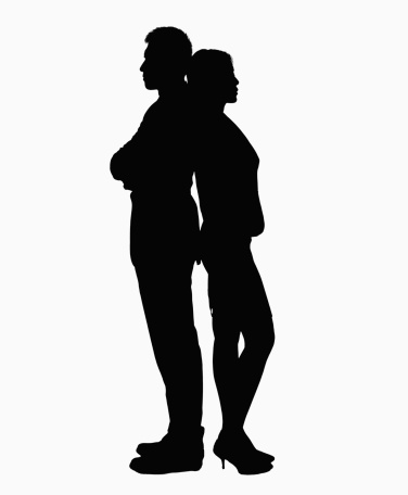 Silhouette of businessman and businesswoman standing back to back.