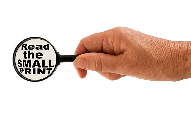 Read the small print warning - hand, magnifying glass message Contract danger concept. read the fine print stock pictures, royalty-free photos & images