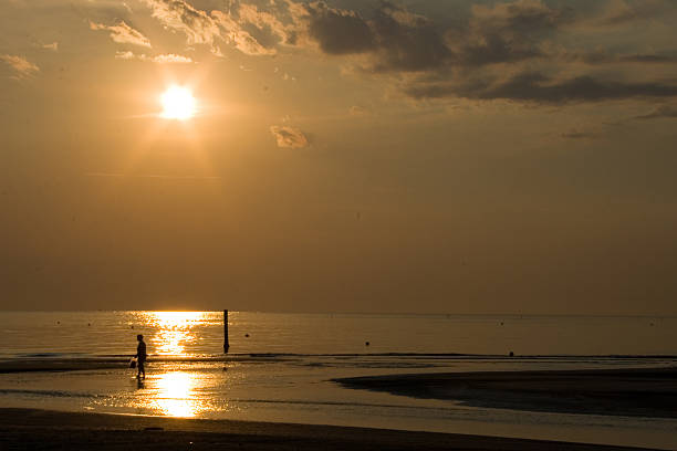 istock walk in sunrise at beach 460795651