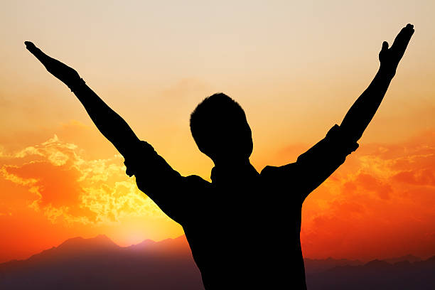 istock Man with beautiful sunset and landscape in the background 460796201