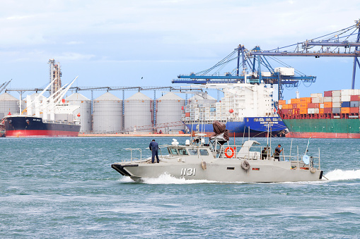 Veracruz, Mexico - November 23, 2013: A Mexican Navy Polaris class patrol boat, with its crew on board, speeding up through the port of Veracruz