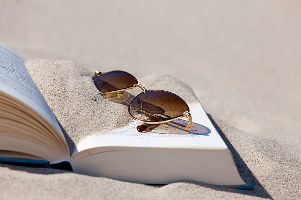 istock Sunglasses lies on an opened book 460817947