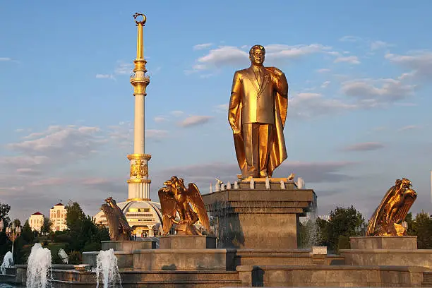 Photo of Monumen of Niyazov and  Independence Arch in sunset. Ashkhabad