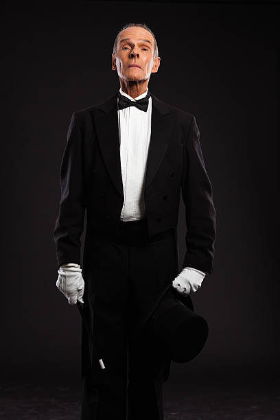 istock Magician with black suit and hat holding a magic stick. 460818863