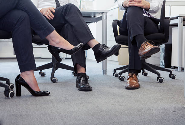istock Three business people with legs crossed, low section 460821043