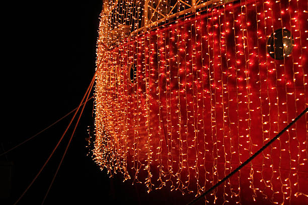 istock Festive party boat covered in lights 460821439