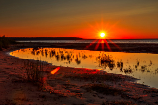 A sinking sun lights up the Lake Superior horizon. Copper Harbor, Michigan.