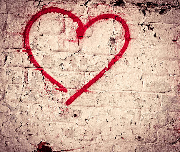 istock Red Love Heart hand drawn on brick wall textured background 460828453