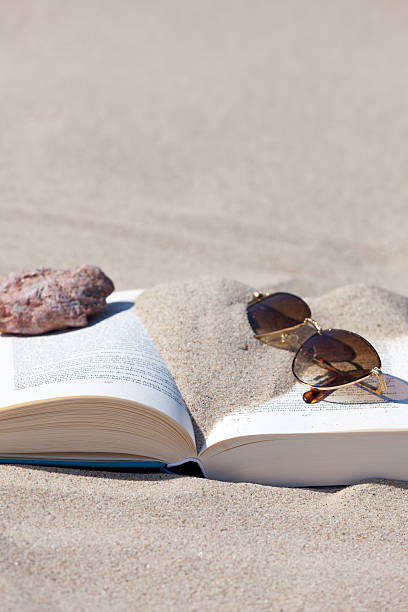 istock Book and Sunglasses on the Beach 460831223