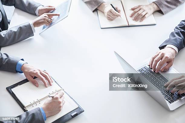Four Business People During A Meeting Hands Only Stock Photo - Download Image Now - Suit, Writing - Activity, Typing