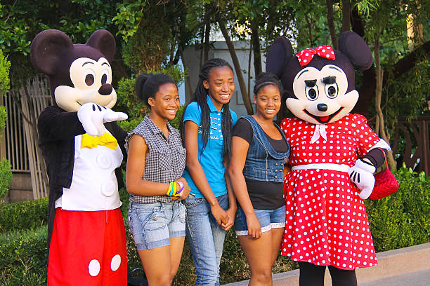 Las Vegas, Nevada, USA - October 21, 2013: Actors in costumes Mickey Mouse  and Mrs. Mickey Mouse posing with tourists for  camera in Las Vegas. Many actors in different costumes entertain tourists