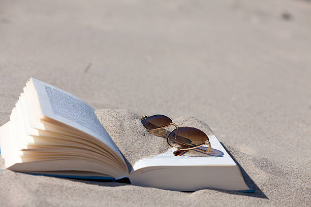 istock Sunglasses lies on an opened book 460842103