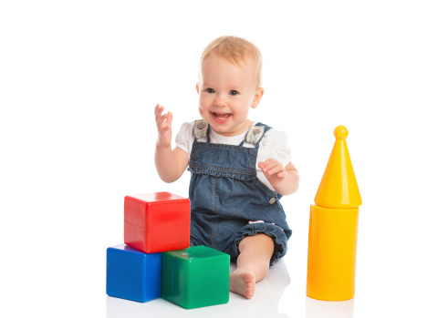 happy cheerful child playing with blocks cubes isolated on white background