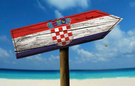 Croatia flag wooden sign with a beach on background