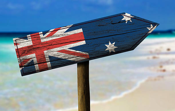 Australia flag wooden sign with a beach on background
