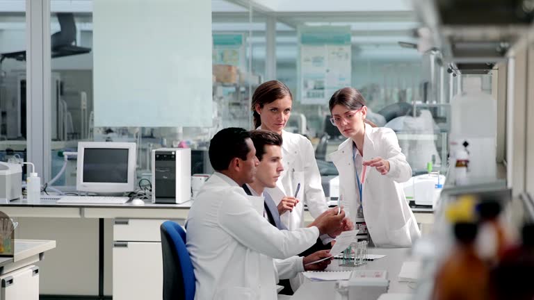 Scientists and businessman talking in laboratory