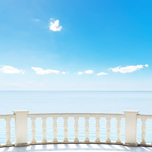 istock white balcony near sea and blue sky 460852373