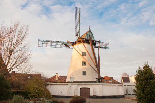 Vintage stone windmill in flanders belgium