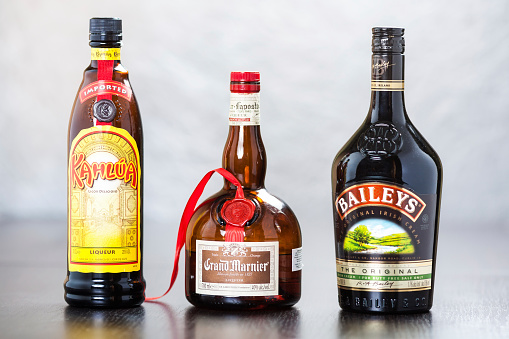 Zagreb, Croatia - December 29, 2013: Bottles of coffee liqueur Kahlua, triple sec Grand Marnier and Bailey's Irish Cream, which in equal parts form the known B-52 cocktail, usually served layered in a shot glass.