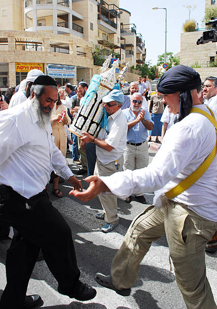 Jerusalem, Israel- April 04, 2007: A group of residents in the Jewish quarter of Har-Homa in Jerusalem singing and dancing to celebrate the arrival of a new Bible Scroll that is being brought to their synagogue.