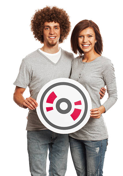 Smiling young couple holding CD sign isolated on white background.