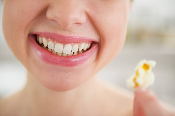 istock Closeup on smiling young woman with popcorn 460871045