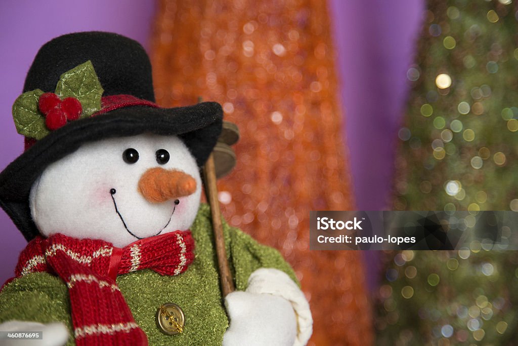 Snowman Portrair of Snowman with blurred christmas tree on background and copy space Candle Stock Photo