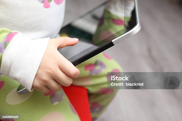 Child Holding A Touch Screen Tablet Stock Photo - Download Image Now - 12-17 Months, Close-up, Communication