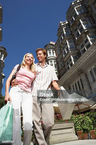 Couple On City Street With Shopping Bags Stock Photo - Download Image Now - Adult, Arm Around, Bag
