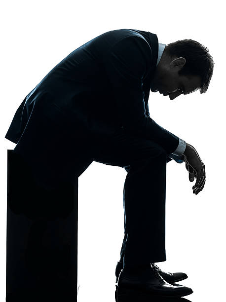 istock sad business man sitting pensive silhouette 460899645