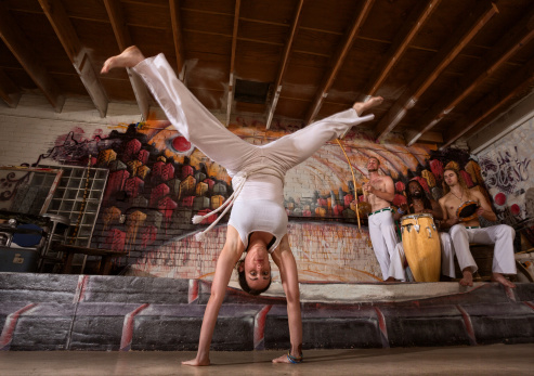 Female capoeira expert performing handstand splits