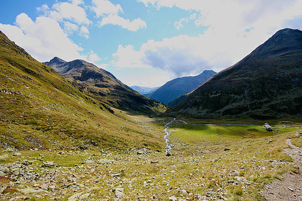 istock Grass alpine meadow surrounded by high mountains, Switzerland. 460901415