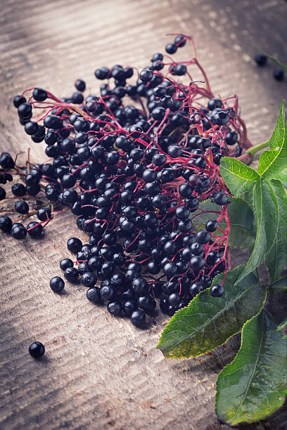 istock Elderberry on wooden background 460906385