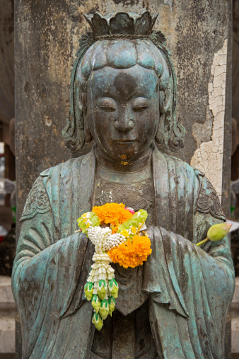 Buddha holding an offering of marigolds.