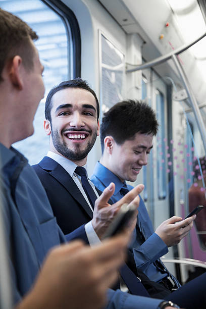 istock Three businessmen sitting in a row and talking on  subway 460915869