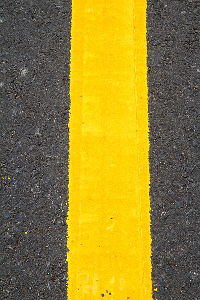 istock yellow line on the road texture background 460919931