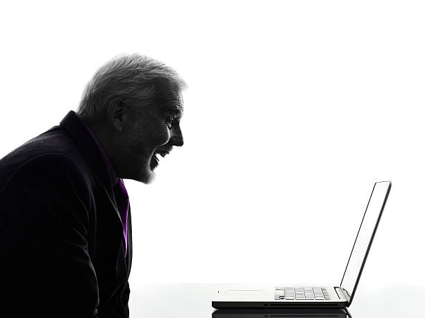 istock senior business man smiling computing laptop silhouette 460920577